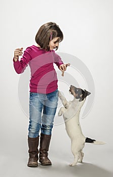 Kid rewarding her dog