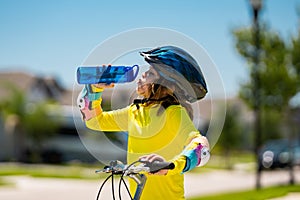 Kid riding bike in a helmet. Child riding bike in protective helmet. Safety kids sports and activity. Happy kid boy