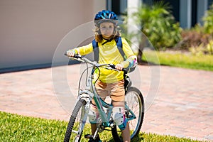 Kid riding bike in a helmet. Child riding bike in protective helmet. Safety kids sports and activity. Happy kid boy