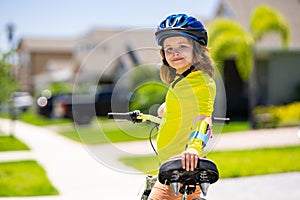 Kid riding bike in a helmet. Child riding bike in protective helmet. Safety kids sports and activity. Happy kid boy