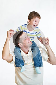 Kid riding father's shoulders