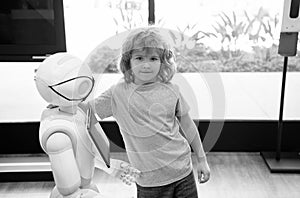 kid and robot assistant with information screen in protective mask. robotic pandemic future