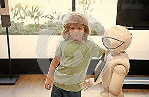 kid and robot assistant with information screen in protective mask. robotic pandemic future