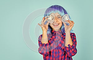 Kid in romantic mood. child on party. copy space. small girl blue wig hold decorative heart. happy valentines day. nice