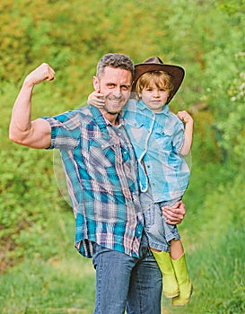 Kid in rubber boots. happy dad in forest. human and nature. family day. happy earth day. Eco farm. small boy help