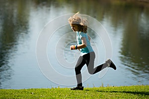 Kid runners run on lawn in park. Child running outdoor. Healthy sport activity for children. Little boy at athletics