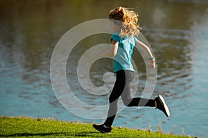 Kid runners run on lawn in park. Child running outdoor. Healthy sport activity for children. Little boy at athletics