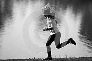 Kid runners run on lawn in park. Child running outdoor. Healthy sport activity for children. Little boy at athletics