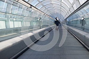 Kid running away on rolling walkway