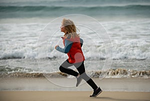 Kid running on beach. Little runner exercising. Child runner jogger running in the nature. Active healthy kids lifestyle