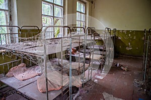 Kid`s bedroom with berths in the kindergarten at the abandoned village Kopachi near Chernobyl