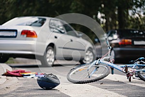 Kid`s bike and helmet on pedestrian crossing after collision wit