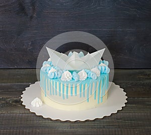 Kid`s cake with wafer paper ship, color drip and merengues