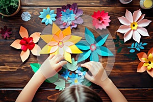 A kid\'s handmade delight: crafting colorful paper flowers, top view