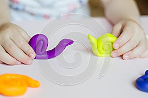 Kid`s hands with homemade plasticine