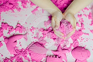 Kid`s hands with kinesthetic sand