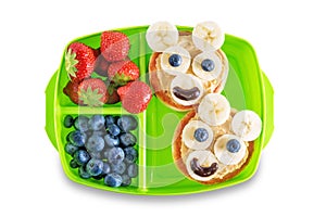 Kid`s healthy breakfasts with funny faces in a container on a white isolated background