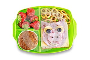 Kid`s healthy breakfasts with funny faces in a container on a white isolated background