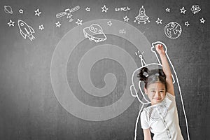 Kid`s learning inspiration in science education with girl child`s imagination doodle on teacher`s school chalkboard for back to sc