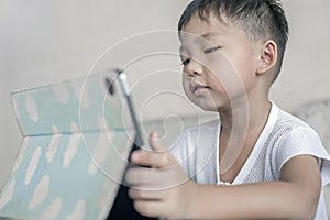 Kid`s using digital touchscreen phone tablet playing online games.