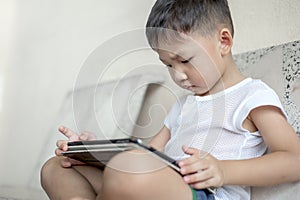 Kid`s using digital touchscreen phone tablet playing online games.