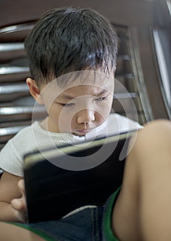 Kid`s using digital touchscreen phone tablet playing online games.