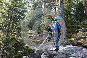 Kid with safety climbing equipment