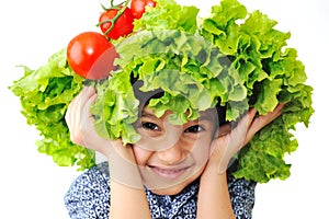 Kid with salad and tomato hat on his head