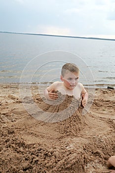 Kid on sandy beach of Lake Seliger