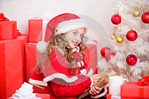 Kid santa hat enjoy christmas eve. Child writing letter to santa claus. Dear santa. Girl little cute child hold pen and