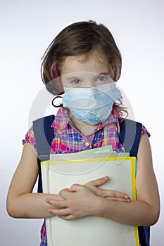 Kid school girl during pandemy going to school with mask