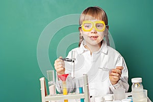 Kid scientist making experiments in home or school laboratory. Child and science education concept