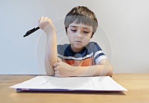 Kid in Self isolation doing his mathematics homework while school off,Child learning math at home during covid lock down,Home