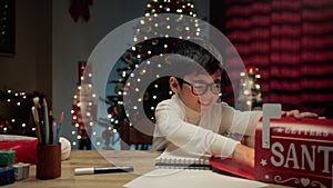 Kid sending Christmas letter to Santa letterbox