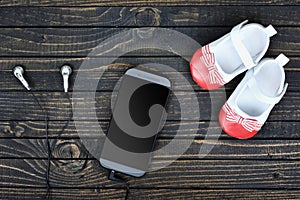 Kid shoes and phone on floor