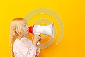 Kid shouting through megaphone. Communication concept. yellow background as copy space for your text