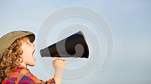 Kid shouting through megaphone photo