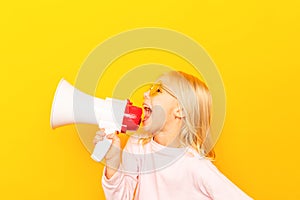 Kid shouting through vintage megaphone. Communication concept. Blue sky background as copy space for your text