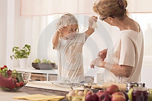 Kid showing cookies to nanny