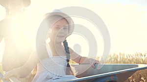 Kid sisters children play with a garden trolley car ride lifestyle on wheelbarrow. little girl child in hat happy family