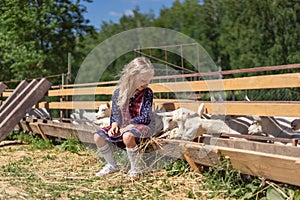 kid sitting on fence at farm and looking