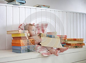 The kid is sitting on the floor in a bright room