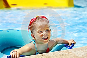 Kid sitting on inflatable ring.