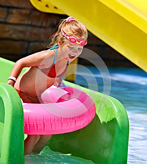 Kid sitting on inflatable ring.