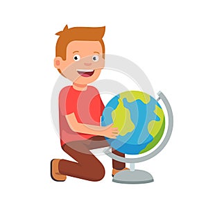 Kid sitting at terrestrial globe