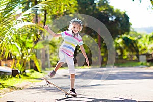 Kid with skateboard. Child riding skate board