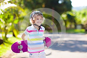 Kid with skateboard. Child riding skate board