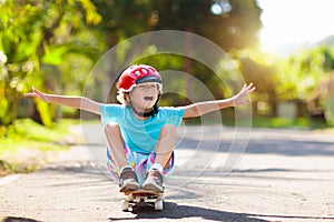 Kid with skateboard. Child riding skate board