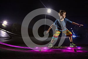 Kid skating in a night park