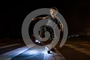 Kid skating in a night park